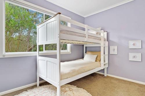 a white bunk bed in a room with a window at Premiere Seaside Home - Relaxing Family Getaway* in Rye