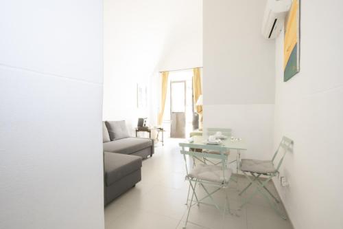 a living room with a couch and a table at Le Tre Sorelle in Bari
