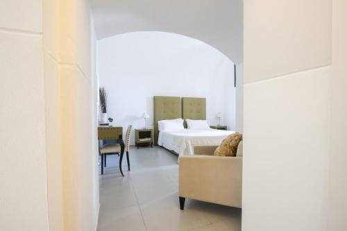 a hotel room with a bed and a couch at Le Tre Sorelle in Bari