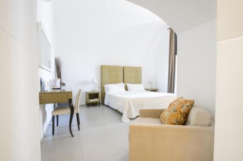 a white bedroom with a bed and a couch at Le Tre Sorelle in Bari