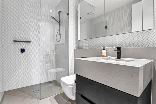 y baño con lavabo, aseo y ducha. en Collins House - Melbourne Cbd Amazing view, en Melbourne