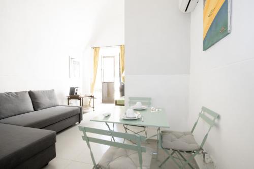 a living room with a glass table and a couch at Le Tre Sorelle in Bari