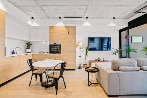 a living room with a couch and a table at Ovation - New Footscray Apt w parking & pool in Melbourne