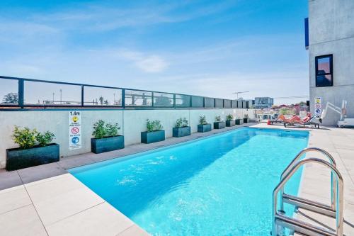 a swimming pool on top of a building at Ovation - New Footscray Apt w parking & pool in Melbourne