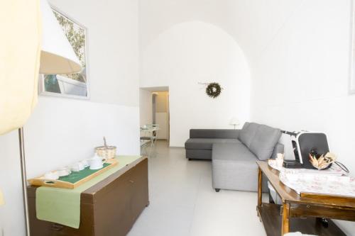 a living room with a couch and a table at Le Tre Sorelle in Bari