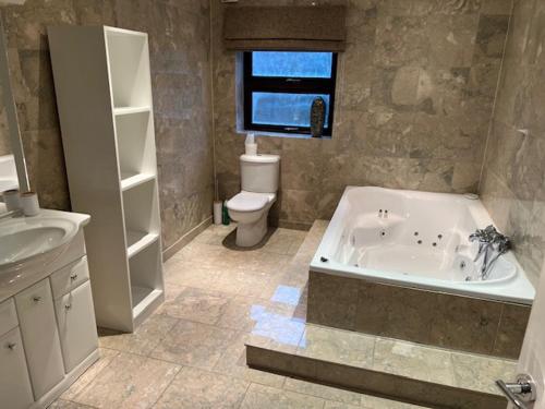 Renishaw的住宿－The House @ Sitwell Arms Hotel，带浴缸、卫生间和盥洗盆的浴室