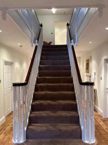 een trap in een huis met een trap bij The House @ Sitwell Arms Hotel in Renishaw