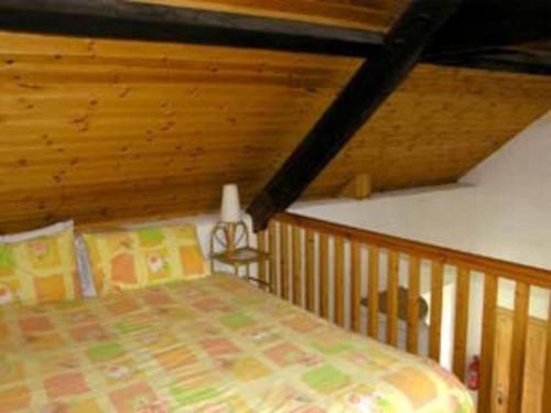 um quarto com uma cama num quarto com tectos em madeira em Deerpark Holiday Cottage (1) em Killaloe