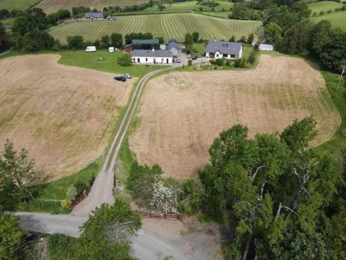 an aerial view of a farm with a house and a road at Deerpark Holiday Cottage (1) in Killaloe