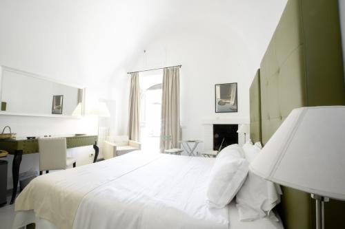 a bedroom with a white bed and a fireplace at Le Tre Sorelle in Bari