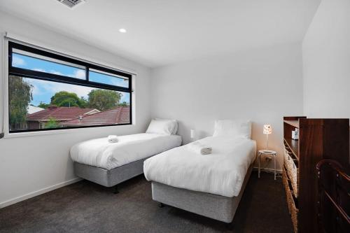 Ένα ή περισσότερα κρεβάτια σε δωμάτιο στο Relaxing Bentleigh Executive Family Getaway