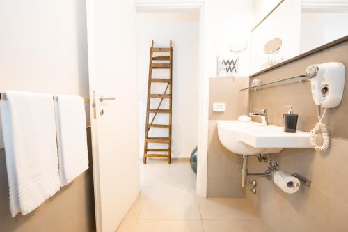 a bathroom with a sink and a mirror and a ladder at Le Tre Sorelle in Bari