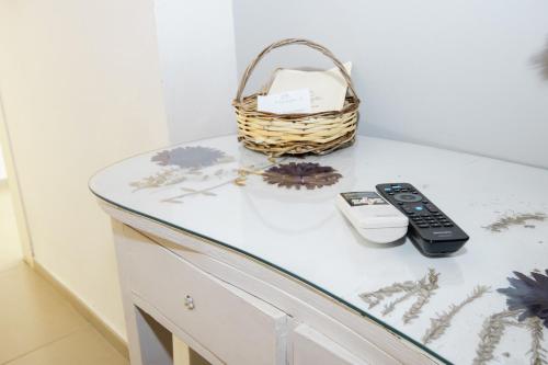 a basket and a remote control sitting on a counter at Le Tre Sorelle in Bari