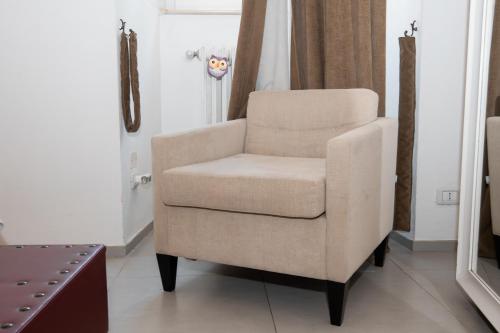 a chair sitting in a room with a window at Le Tre Sorelle in Bari