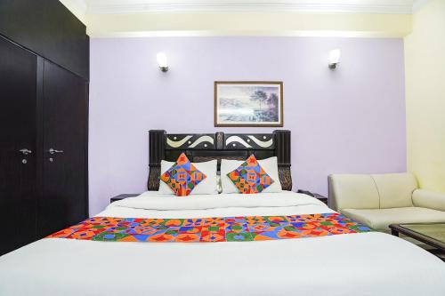 a bedroom with a bed and a couch at FabExpress IVY Inn Sector 35 in Noida