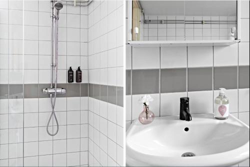 a bathroom with a shower and a sink at Forenom Hotels & Apartments Stockholm Alvik in Stockholm