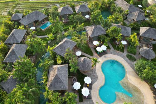 an aerial view of a resort with a pool and trees at Tongna Cottage Natural Resort in Chiang Mai