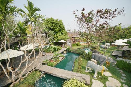 an aerial view of a garden with animals in a river at Tongna Cottage Natural Resort in Chiang Mai