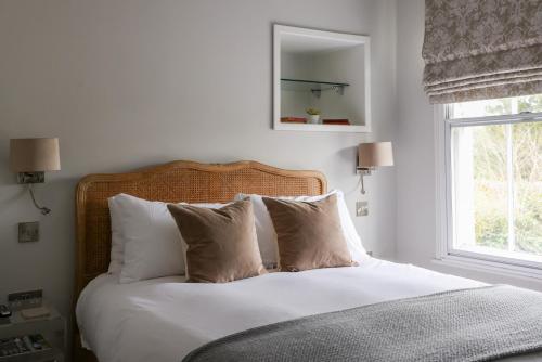 a bedroom with a bed with white sheets and pillows at The Goudhurst Inn in Goudhurst