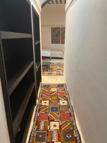 a hallway with a colorful rug on the floor at RiadLalZahra in Rabat