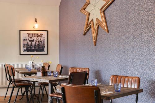 a dining room with tables and a star on the wall at The Goudhurst Inn in Goudhurst