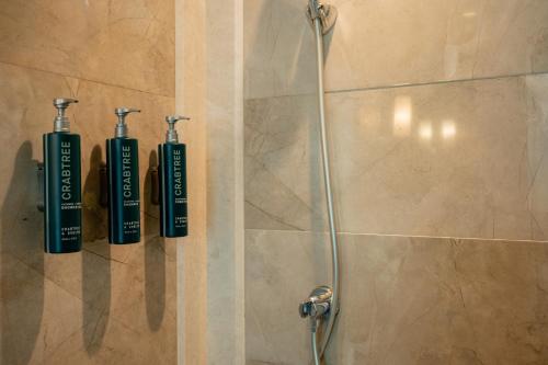 a shower with two shampoo bottles in a bathroom at DoubleTree by Hilton-Pune Chinchwad in Pune