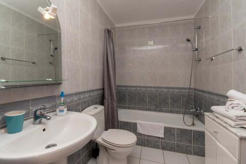 a bathroom with a sink and a toilet and a shower at Paloma Beach 10 - One Bed with sea view and wifi internet in Los Cristianos
