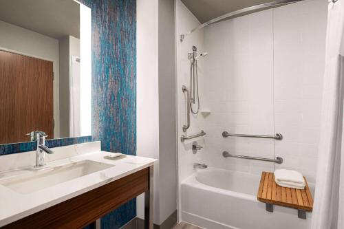 a bathroom with a sink and a tub and a shower at La Quinta Inn & Suites by Wyndham Marysville in Marysville
