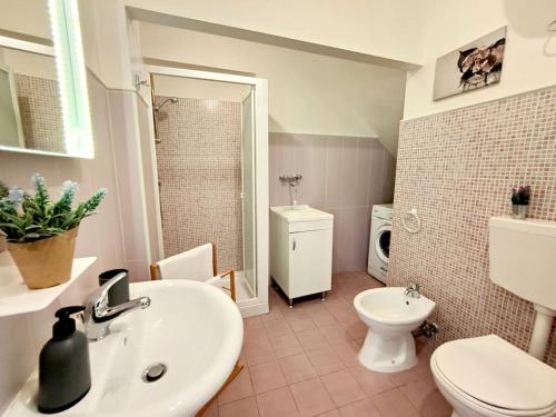 a bathroom with a sink and a toilet at siciliacasevacanze - Pola Home in Marina di Ragusa