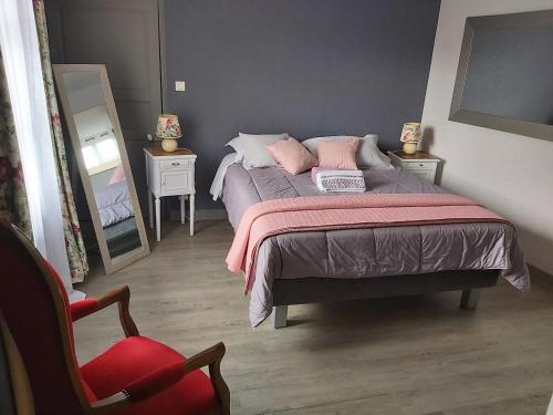 1 dormitorio con cama, silla y espejo en LA PASSIFLORE, en Azé