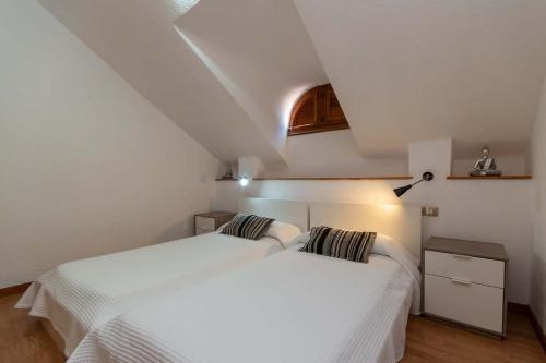 a bedroom with two white beds in a attic at Park Santiago II 178 - Two Bed in Playa de las Americas
