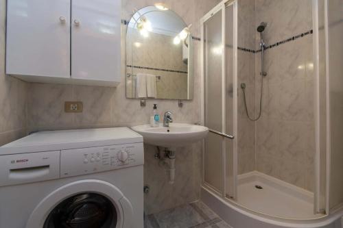 a bathroom with a washing machine and a sink at Park Santiago II 178 - Two Bed in Playa de las Americas