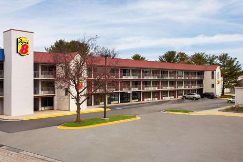 a hotel with a parking lot in front of it at Super 8 by Wyndham Baltimore Northwest in Baltimore
