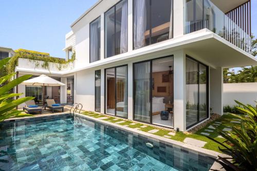an image of a villa with a swimming pool at Wyndham Hoi An Royal Beachfront Resort & Villas in Hoi An
