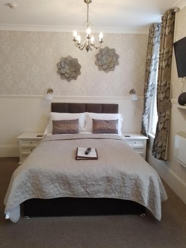 a bedroom with a bed with a tray on it at Sunflower Lodge in Bridlington