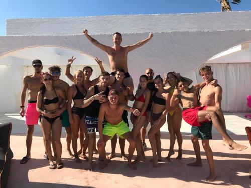 a group of people posing for a picture at the beach at BLACK AMBER BOUTIQUE HOTEL in Lampi