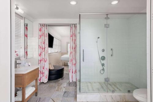 a bathroom with a shower and a toilet and a sink at Townhouse Hotel by LuxUrban in Miami Beach