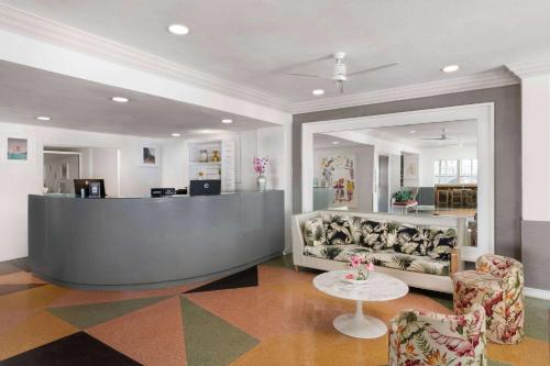 a lobby with a waiting area with a couch and a table at Townhouse Hotel, BW Signature Collection in Miami Beach