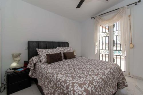 a bedroom with a large bed and a window at Villa Melua in Chayofa