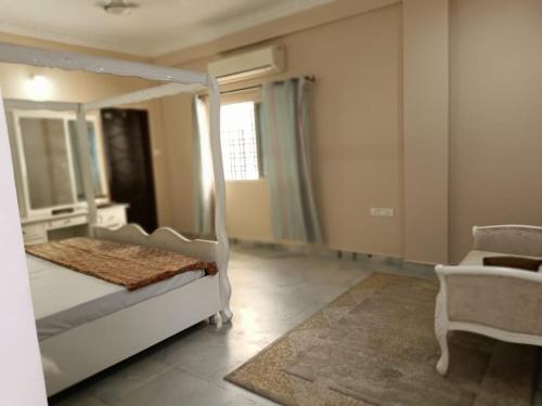 a bedroom with a white bed and a mirror at 3-Bedroom Elegant and Spacious AC Apartment only for families, Prime Location, Just 100m from Main Road! in Hyderabad