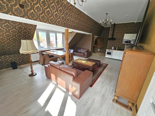 a living room with a couch and a table at Square apartments in Rokiškis