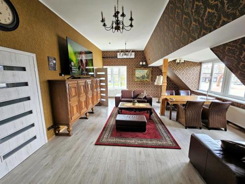 a living room with a couch and a table at Square apartments in Rokiškis