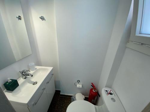 a white bathroom with a sink and a toilet at SUN KISS HOUSES Sun Kiss Houses B in Áyios Spirídhon