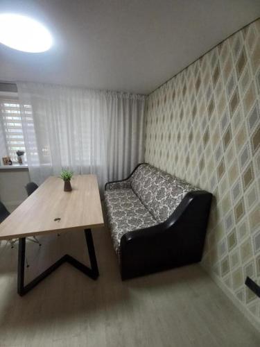 a small room with a bed and a table at Rose Valley Chisinau in Chişinău