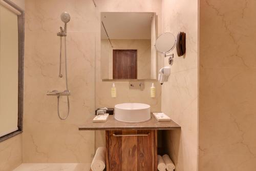a bathroom with a sink and a shower at Lemon Tree Hotel, Kasauli in Kasauli