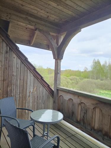 a patio with chairs and a table on a porch at Stadnina Koni Nad Wigrami in Mikolajewo