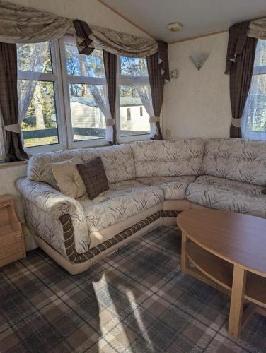 a living room with a couch and a table at Lyndhurst 39 in Dunoon