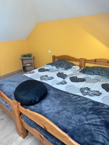 a bedroom with a bed with a blue comforter at Le zen in La Milesse