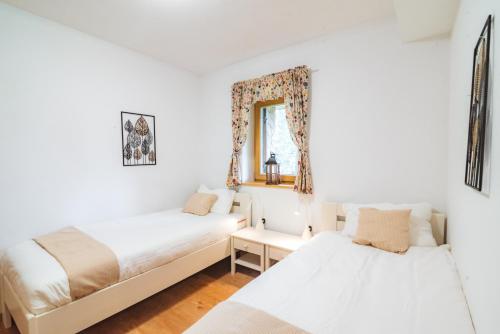 a bedroom with two beds and a mirror at Rogla Alpina Residence in Zreče