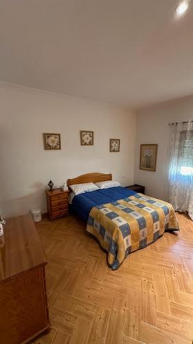 a bedroom with a bed and a wooden floor at Casa Rozita Self Check In 24h in Granadilla de Abona